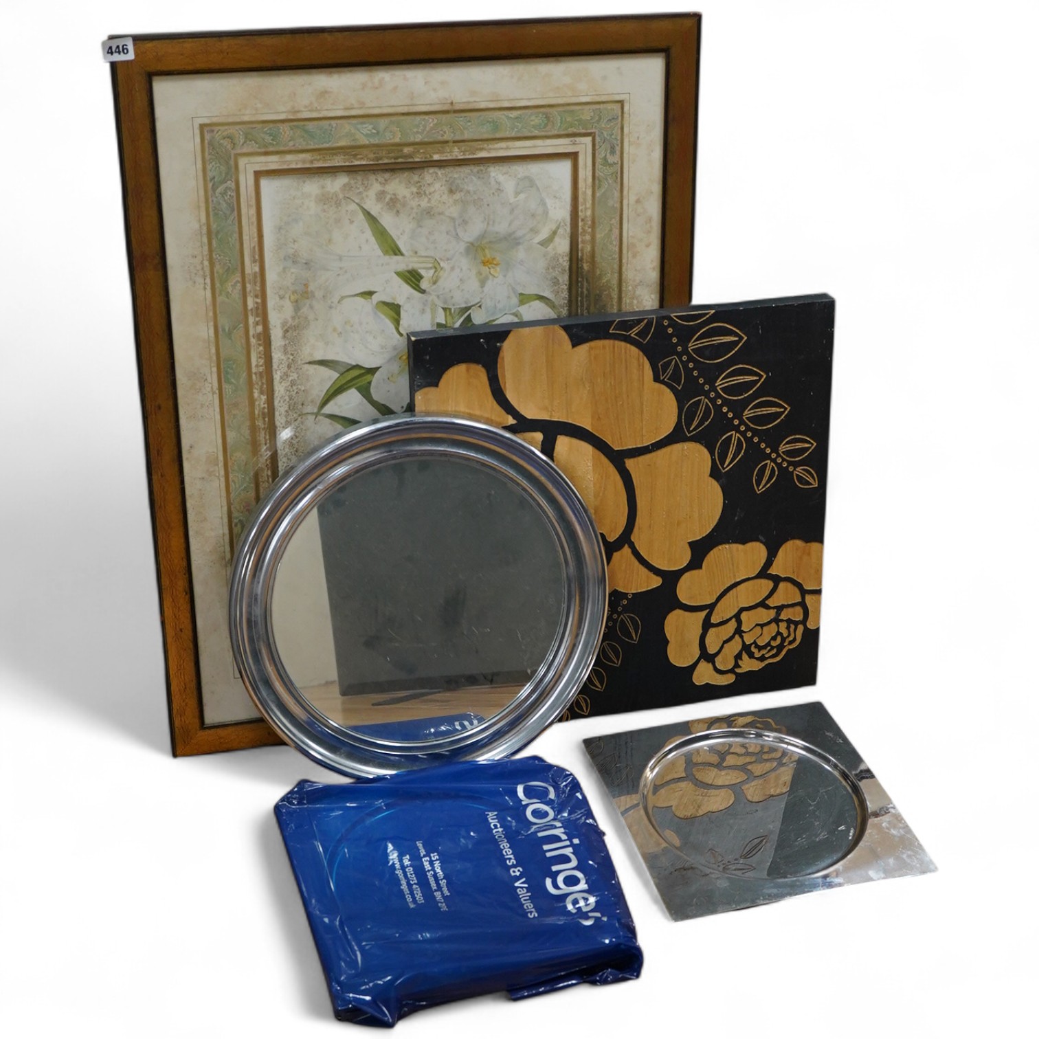 A framed botanical print, circular mirror, floral wood block and a set of metal place mats